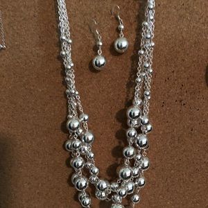 Silver necklace with matching earrings.